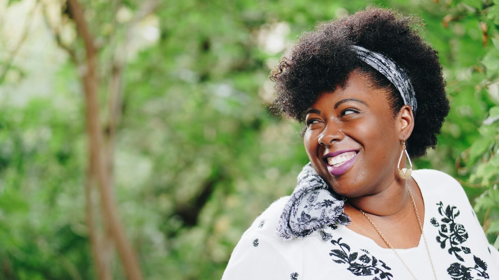 smiling woman looking on right side during daytime