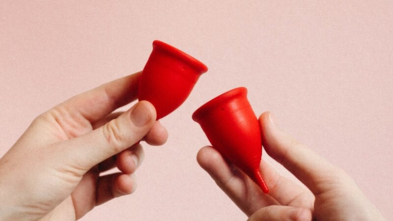 person holding red heart shape ornament