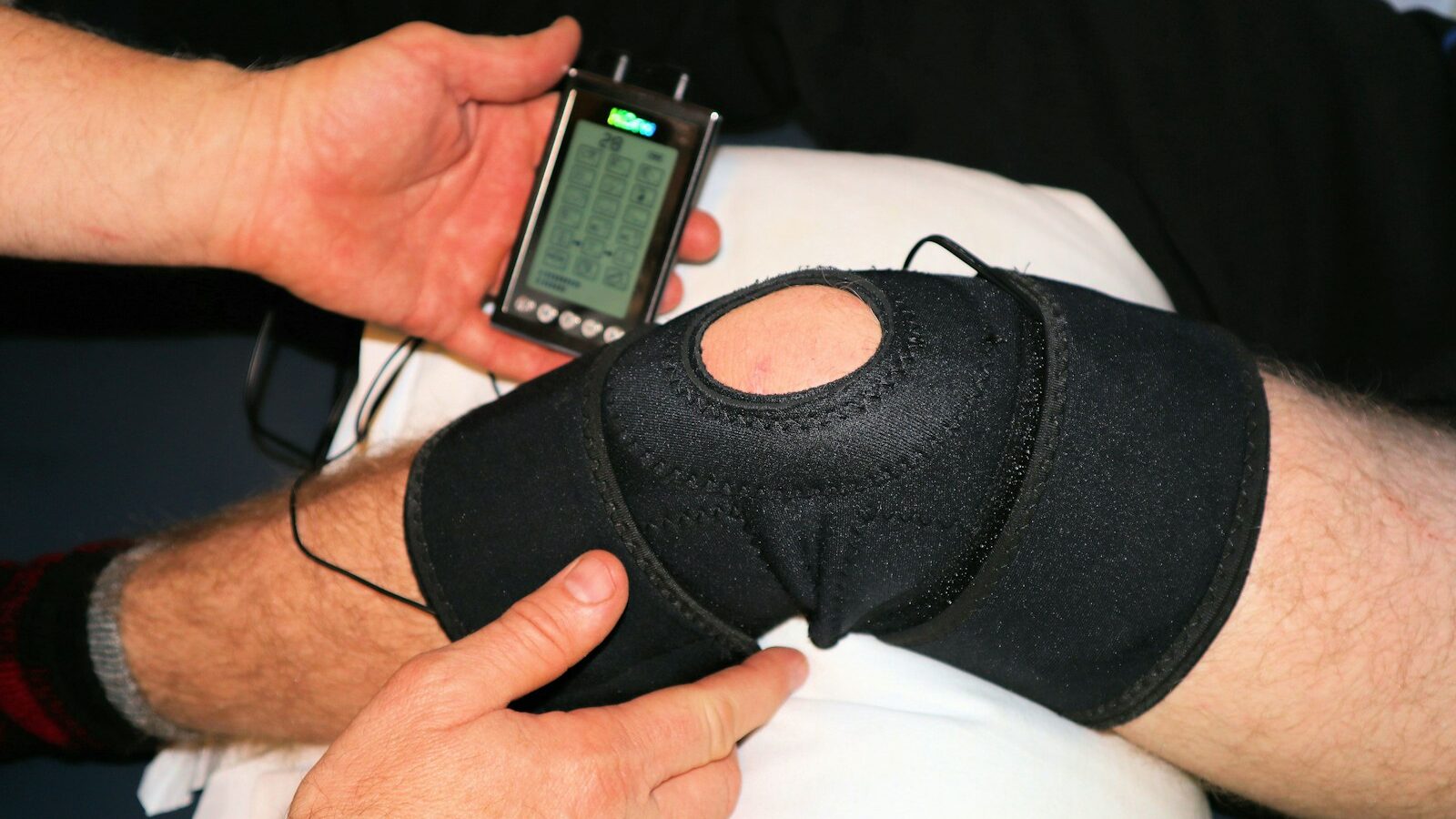 person holding black knit cap