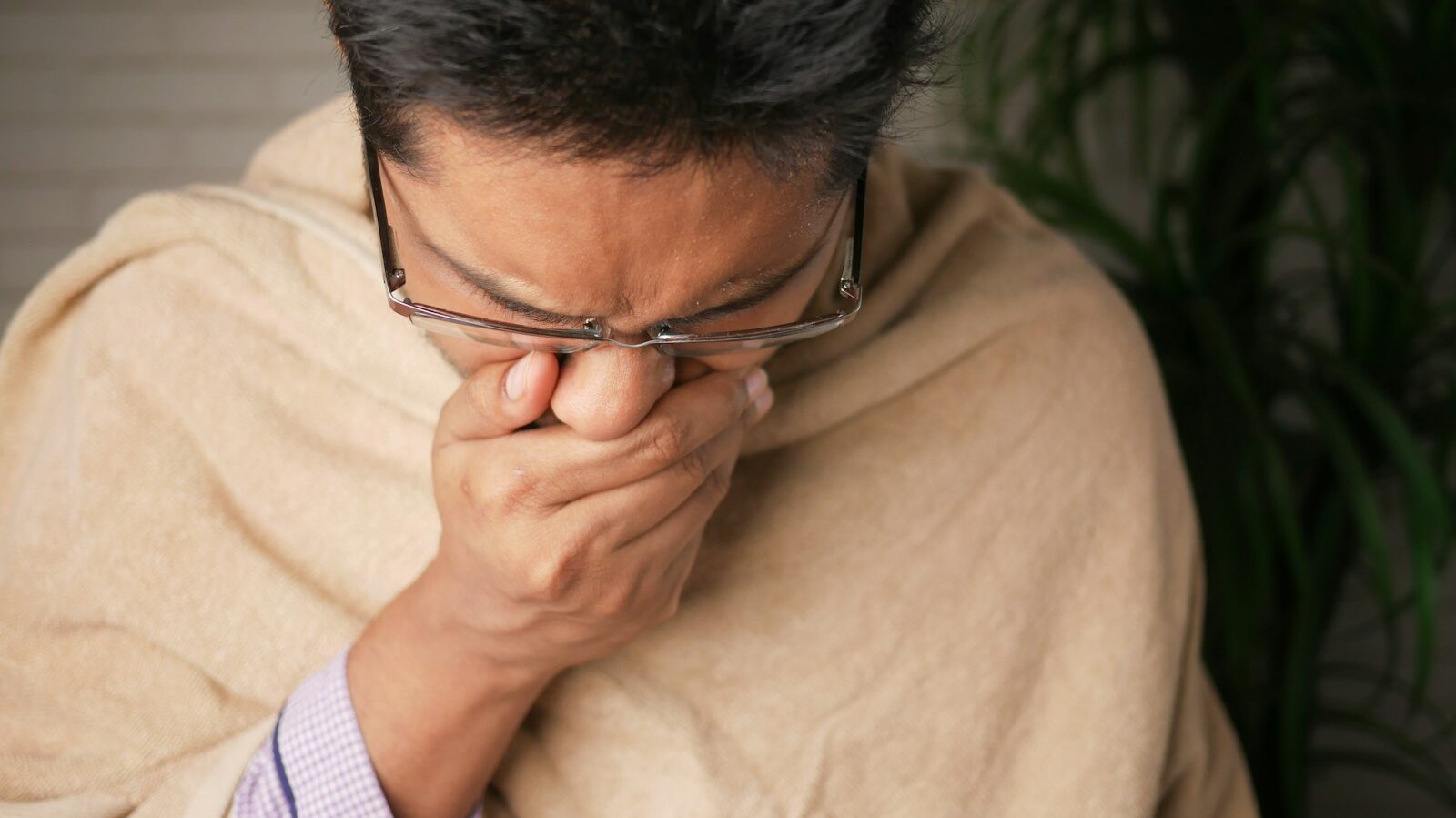 man in brown sweater wearing black framed eyeglasses