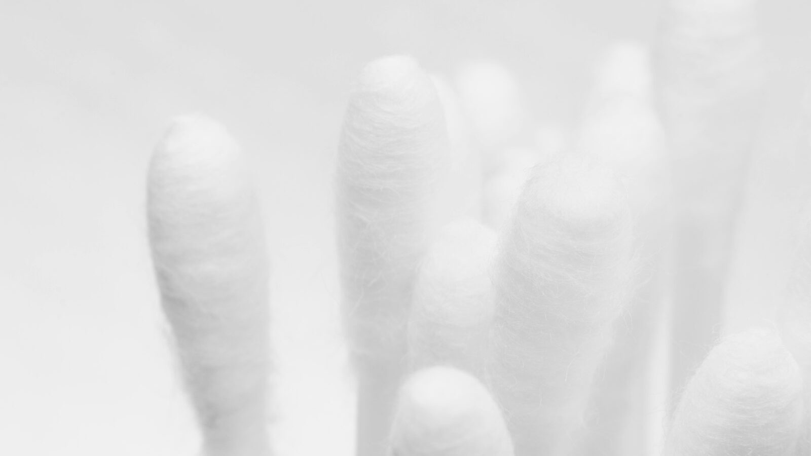 persons hand on white textile