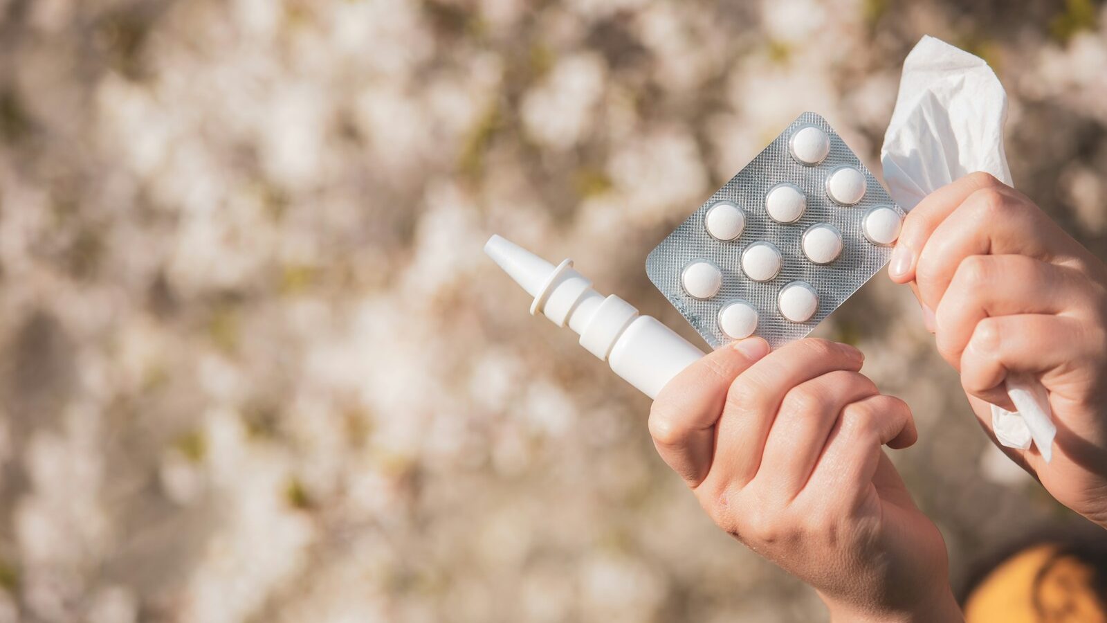a person holding a pack of pills in their hand