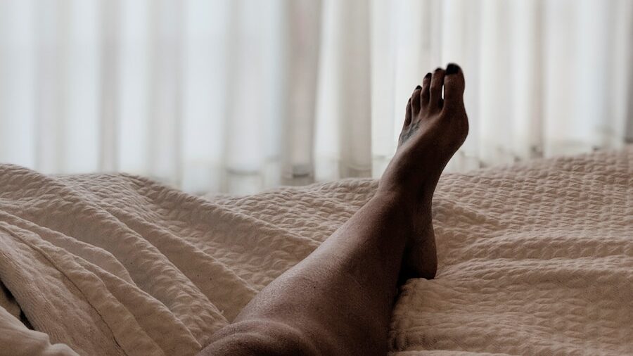 person lying on brown bed sheet
