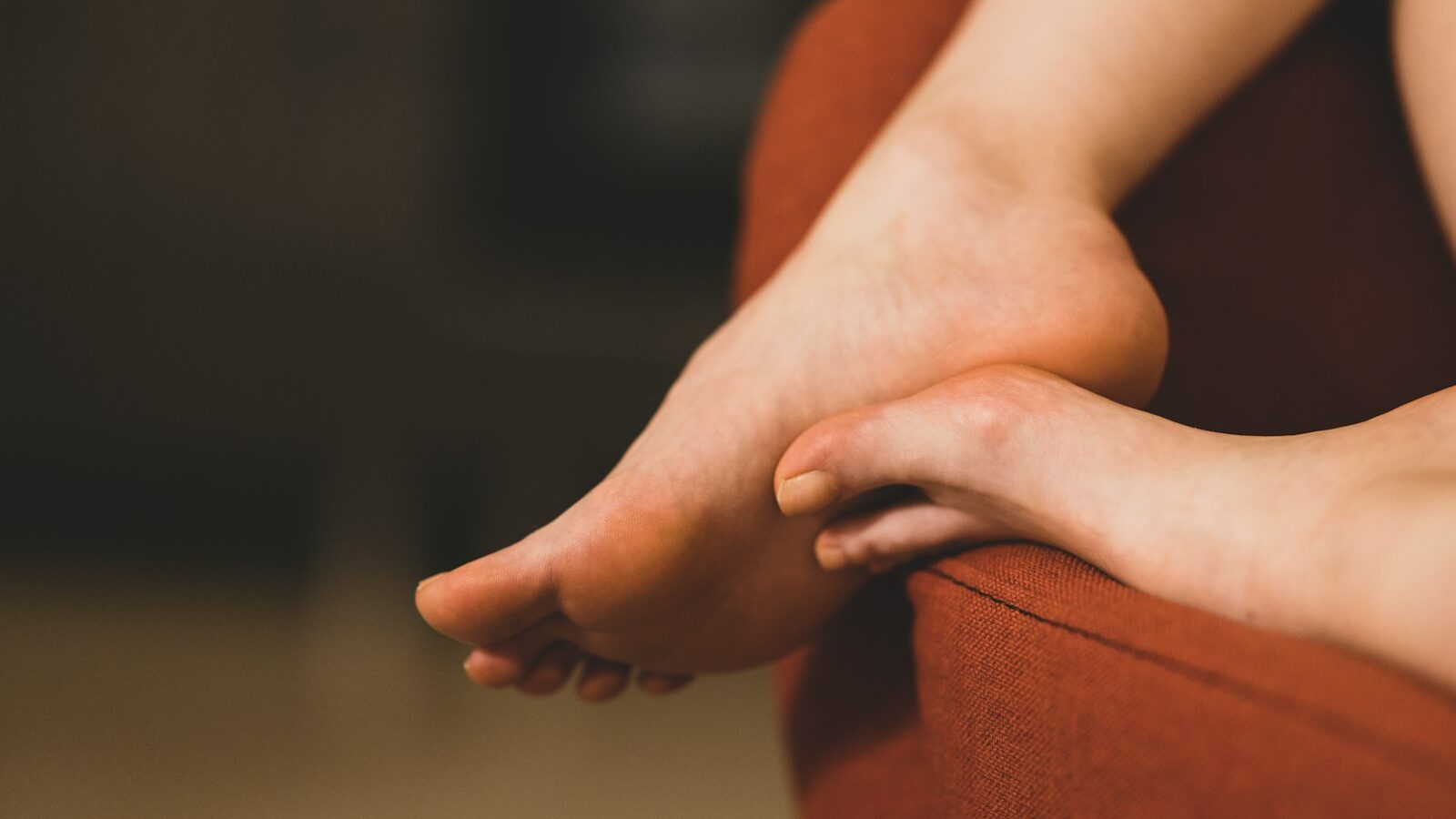 persons feet on brown textile